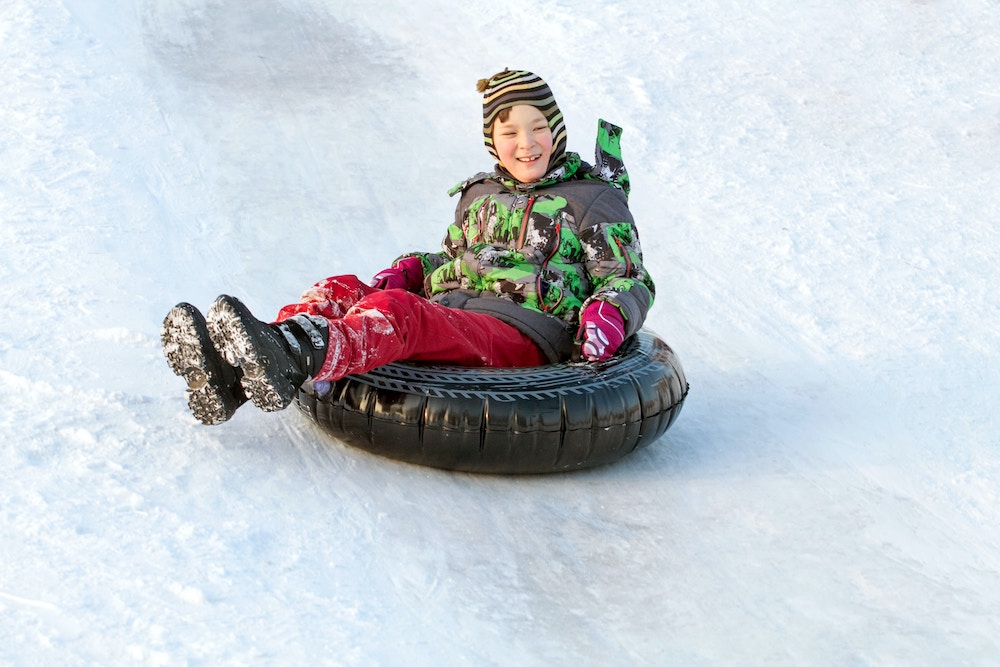 two people tubing down the mountain